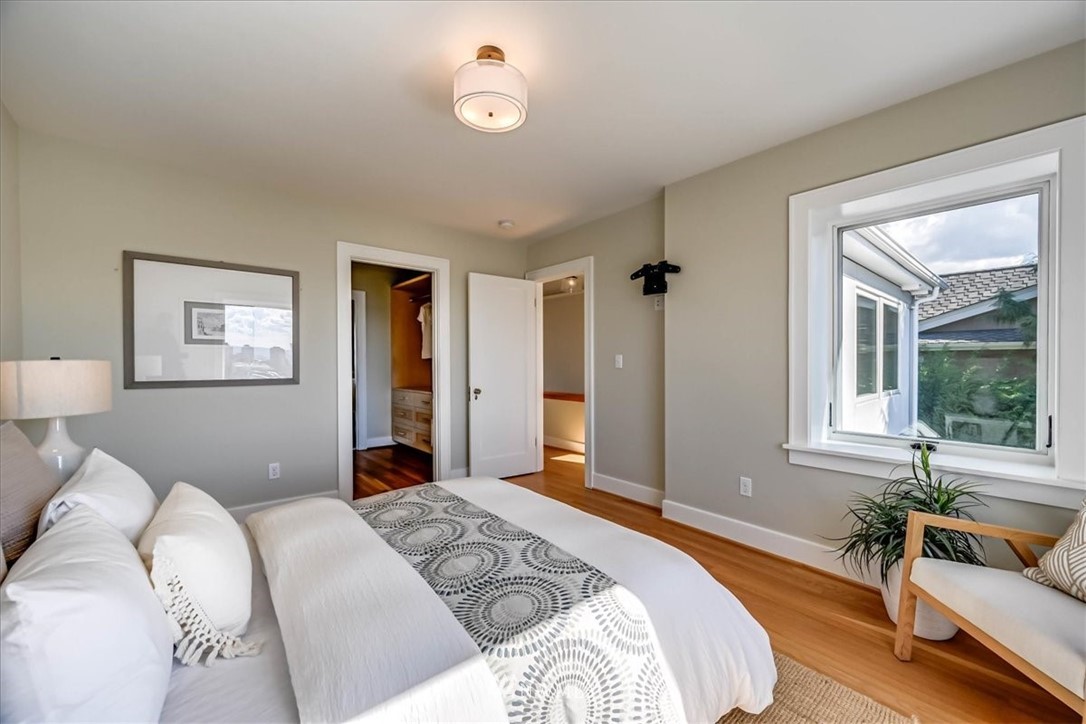 357 Highland Drive Seattle, WA 98109 - Photo 16 of 38 a bedroom with a large bed couch and a window