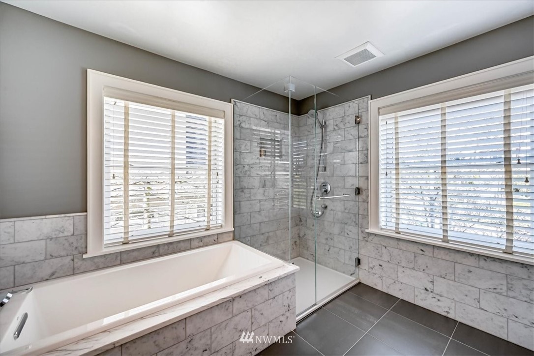 357 Highland Drive Seattle, WA 98109 - Photo 23 of 38 a bathroom with a bathtub and a shower