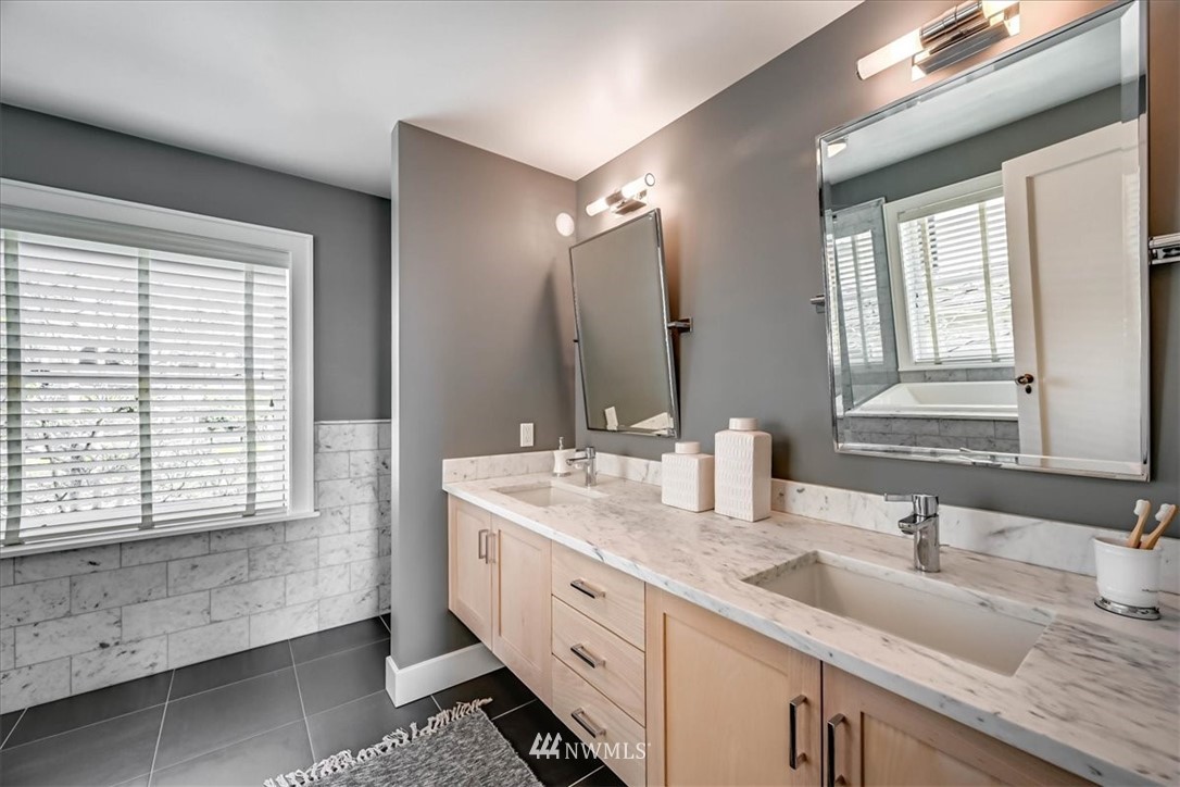 357 Highland Drive Seattle, WA 98109 - Photo 24 of 38 a spacious bathroom with double sink and a mirror