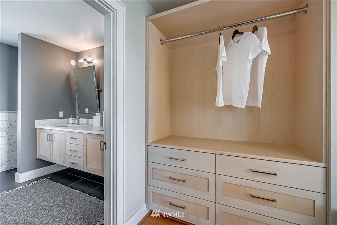 357 Highland Drive Seattle, WA 98109 - Photo 25 of 38 a bathroom with a double vanity sink mirror and shower