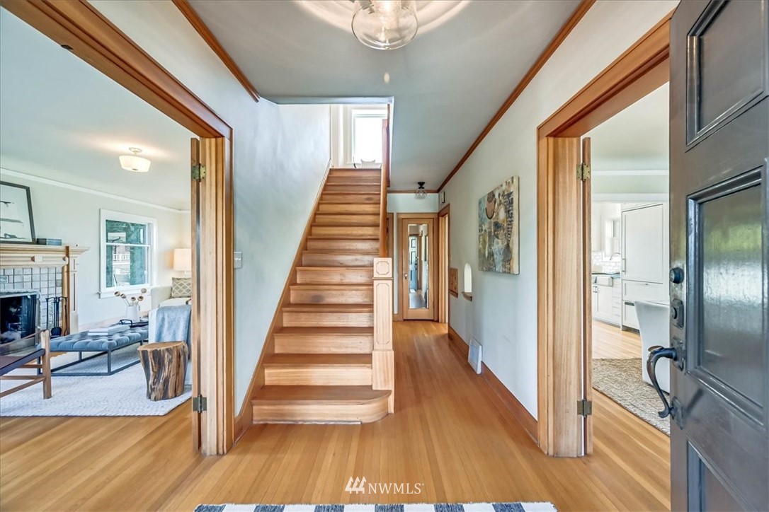 357 Highland Drive Seattle, WA 98109 - Photo 5 of 38 a view of a hallway with wooden floor and staircase