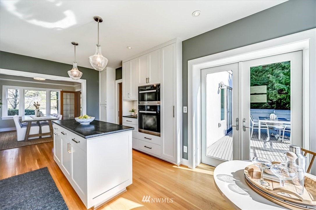 357 Highland Drive Seattle, WA 98109 - Photo 9 of 38 a kitchen that has a stove and a wooden floor