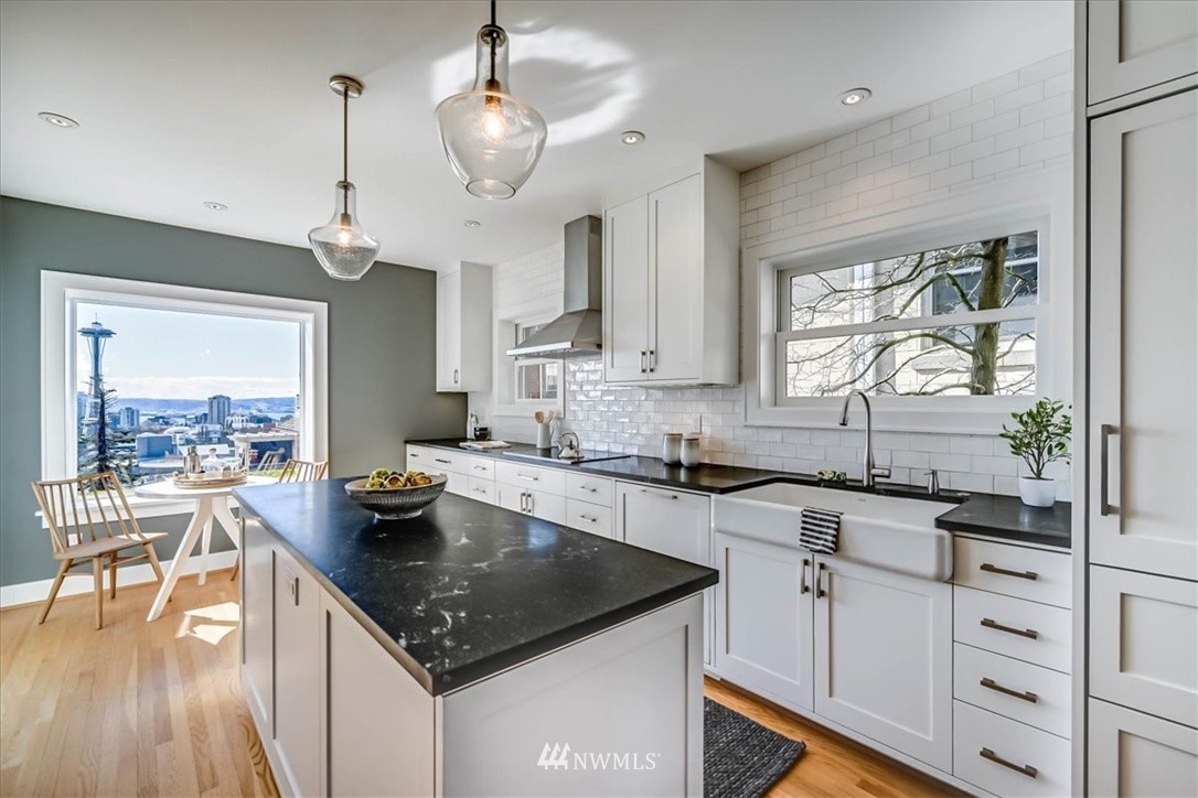357 Highland Drive Seattle, WA 98109 - Photo 10 of 38 a kitchen with a center island appliances and a large window