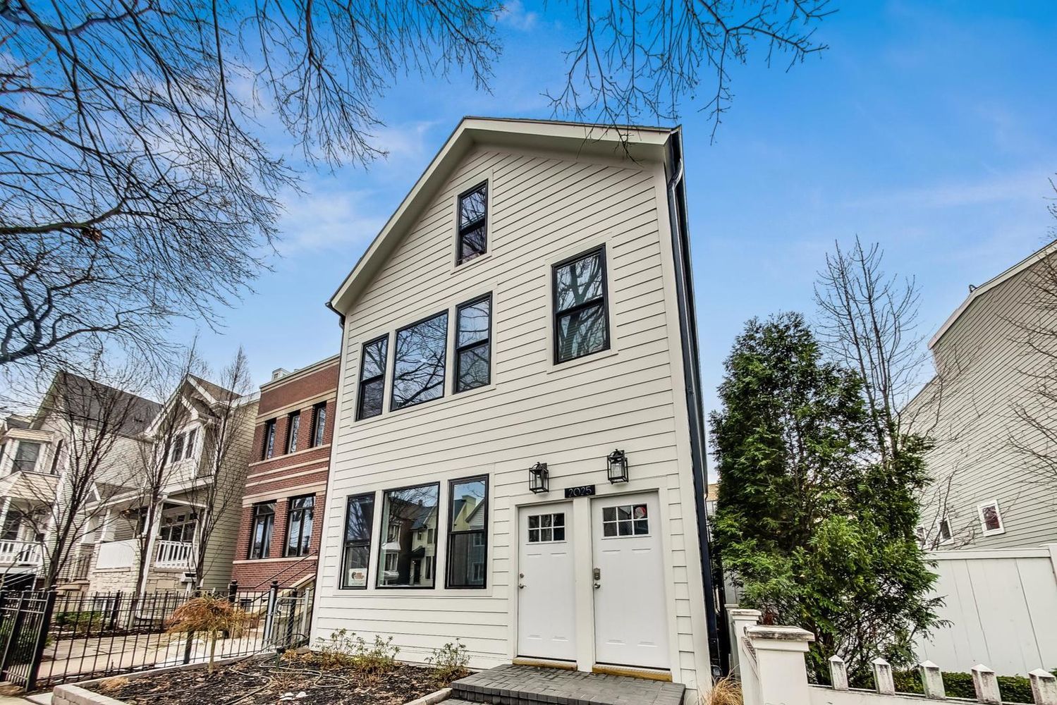 2025 West Melrose Street, Unit 2F Chicago, IL 60618 - Photo 2 of 18 a front view of a house with a yard