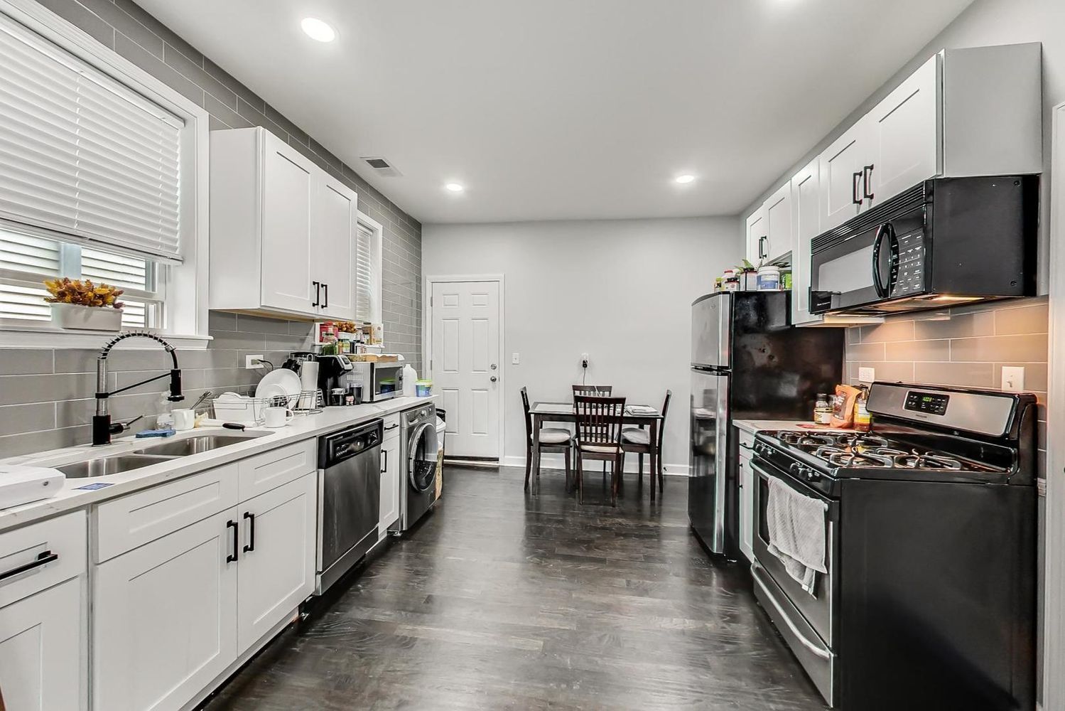 2025 West Melrose Street, Unit 2F Chicago, IL 60618 - Photo 10 of 18 a kitchen with stainless steel appliances a stove sink microwave and cabinets