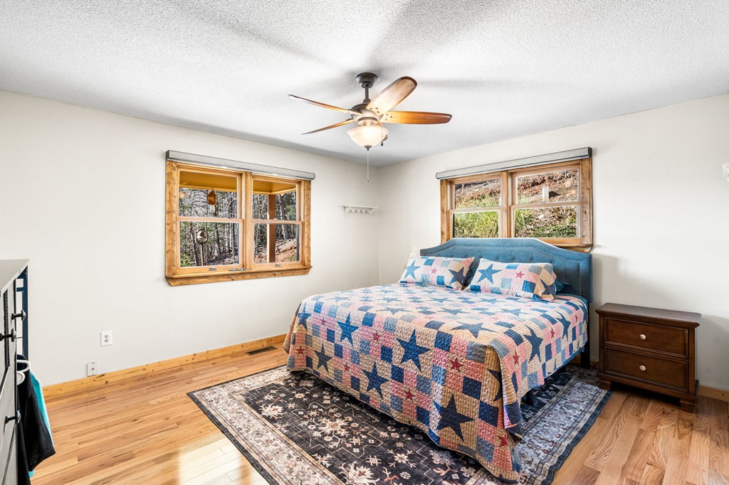 224 Shake Rag Road Hiawassee, GA 30546 - Photo 28 of 47 a bedroom with a bed a dresser and a window