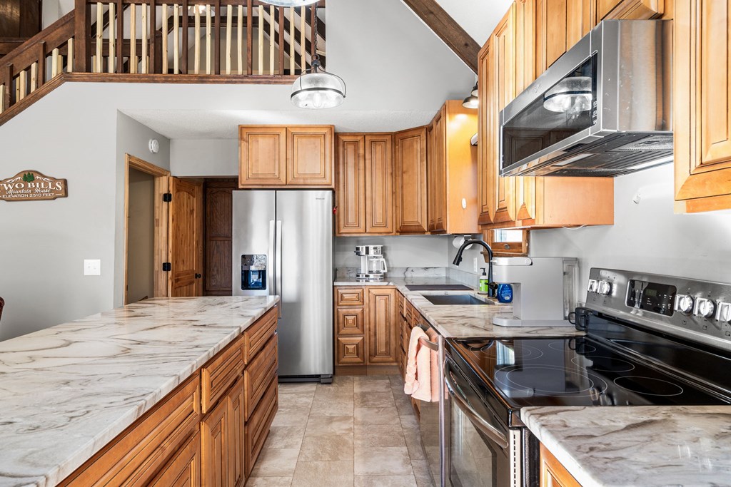 224 Shake Rag Road Hiawassee, GA 30546 - Photo 30 of 47 a kitchen with stainless steel appliances granite countertop a stove a sink dishwasher and refrigerator