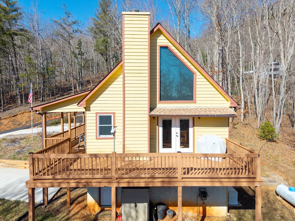 224 Shake Rag Road Hiawassee, GA 30546 - Photo 3 of 47 a view of a house with a balcony and wooden stairs