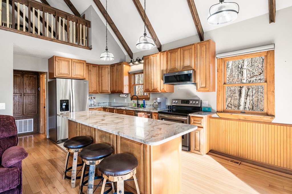 224 Shake Rag Road Hiawassee, GA 30546 - Photo 31 of 47 a kitchen with stainless steel appliances granite countertop a stove and a refrigerator