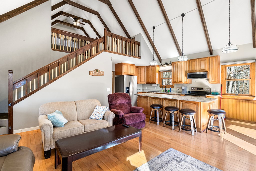 224 Shake Rag Road Hiawassee, GA 30546 - Photo 32 of 47 a living room with furniture a rug and kitchen view
