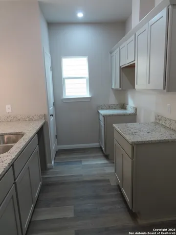 a kitchen with a sink stove and cabinets