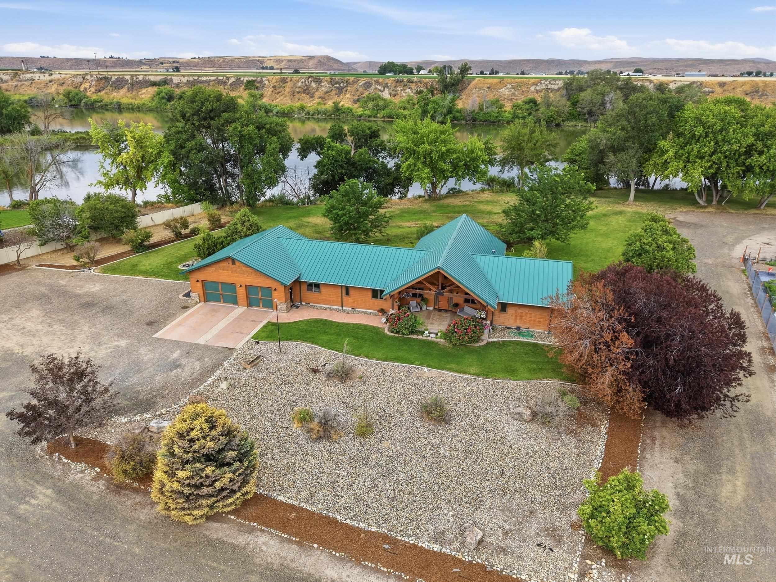 339 Airport Road Weiser, ID 83672 - Photo 1 of 49 Waterfront property featuring a wood-sided exterior and a turquoise metal roof