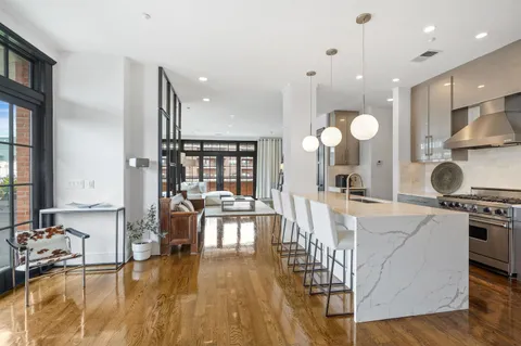 a large kitchen with lots of counter space and a wooden floor