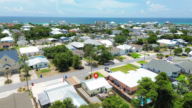 an aerial view of residential houses with outdoor space
