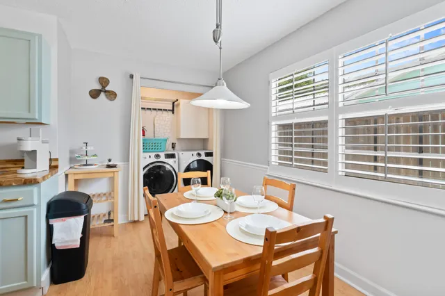 a dining room with furniture a chandelier and window