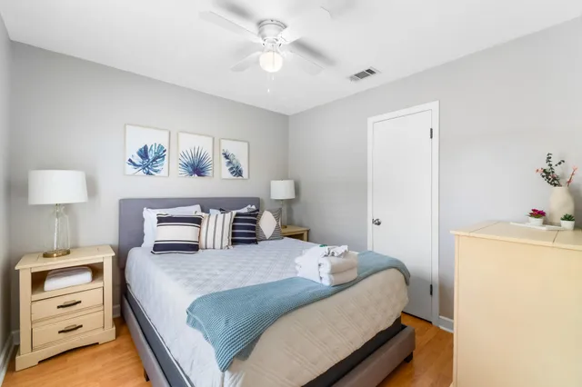 a bedroom with a bed and a chandelier