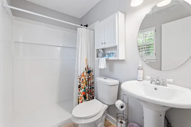 a white toilet sitting next to a bathroom sink