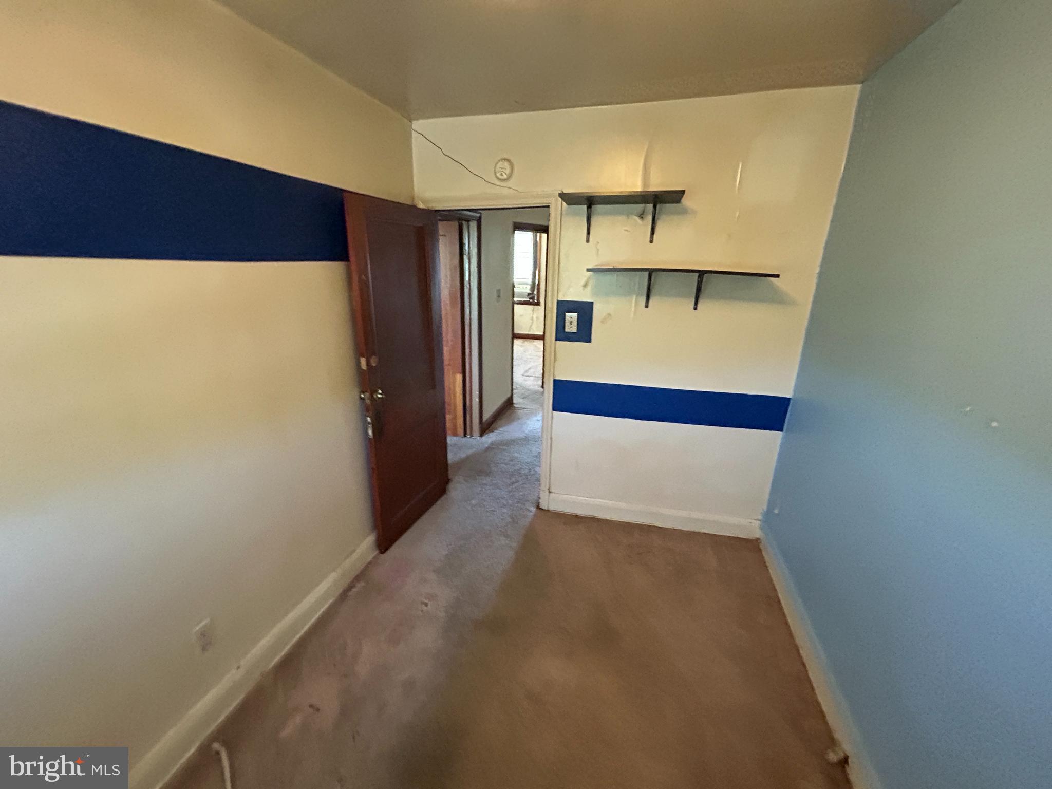 4014 Century Road Baltimore, MD 21206 - Photo 17 of 19 a hallway with sliding door and refrigerator