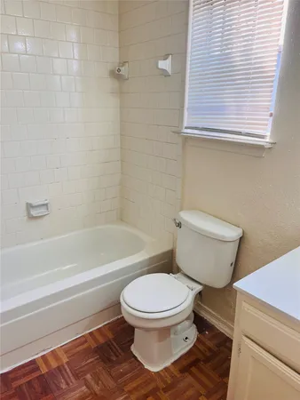 a bathroom with a toilet and a bathtub