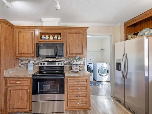 a kitchen with stainless steel appliances kitchen island a stove and a refrigerator