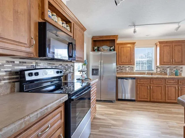 a kitchen with a stove a sink and a refrigerator
