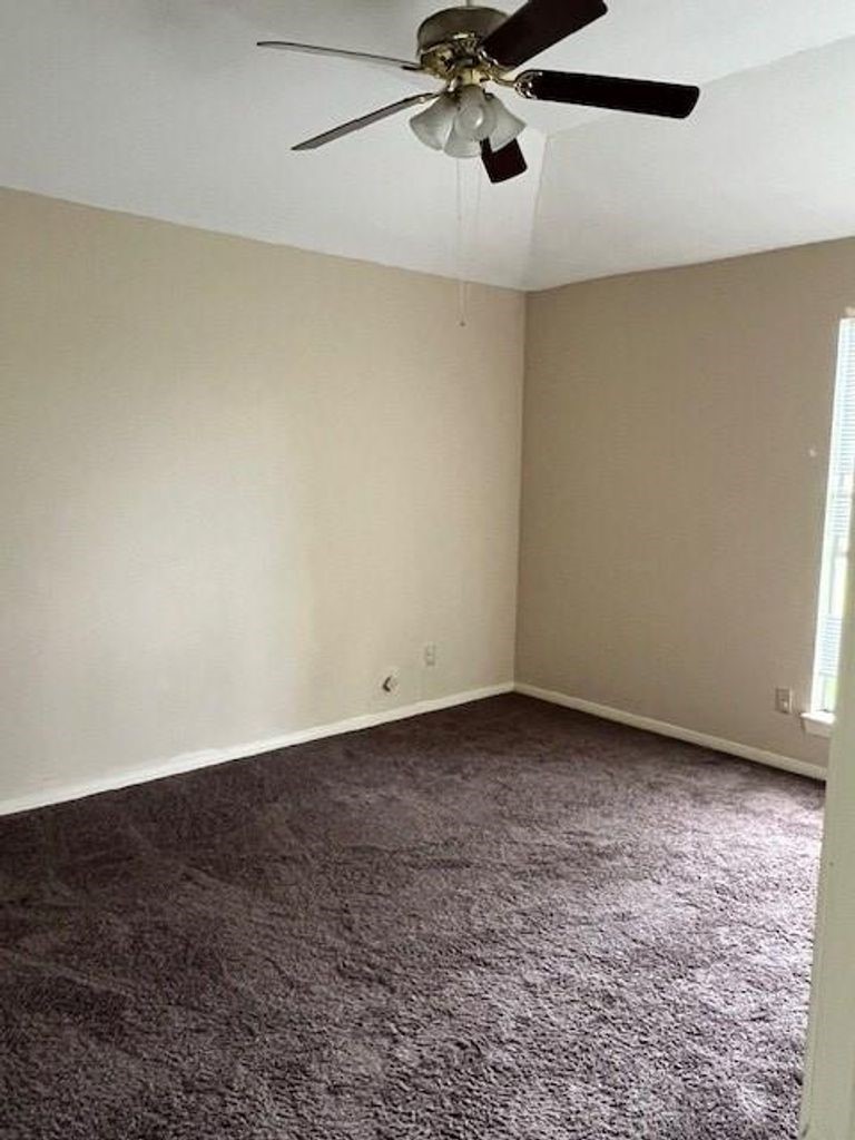 4409 Rattan Avenue Bay City, TX 77414 - Photo 12 of 13 a view of a room with a ceiling fan and window