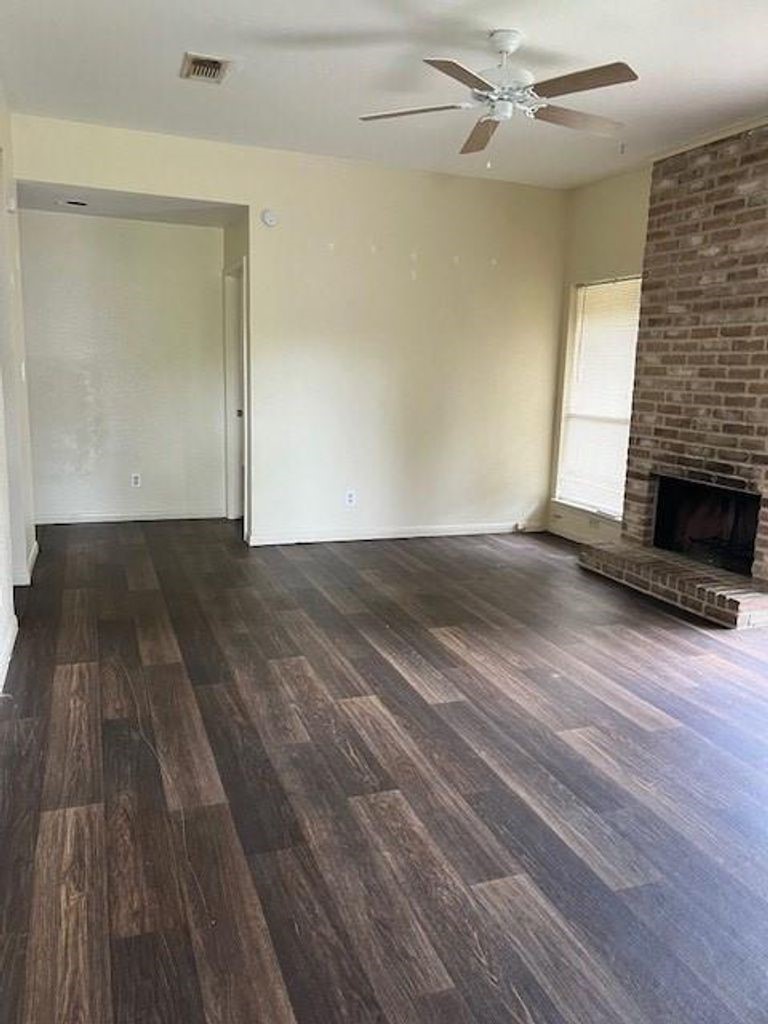 4409 Rattan Avenue Bay City, TX 77414 - Photo 3 of 13 a view of empty room with wooden floor and fireplace