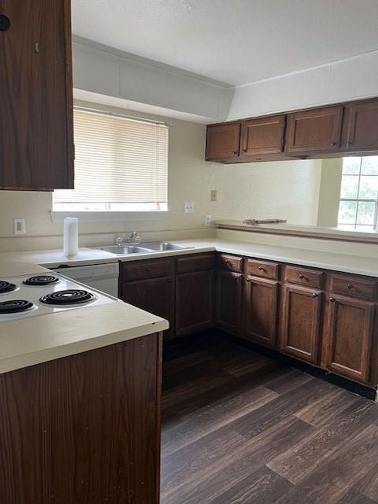 4409 Rattan Avenue Bay City, TX 77414 - Photo 4 of 13 a kitchen with a sink and a stove top oven