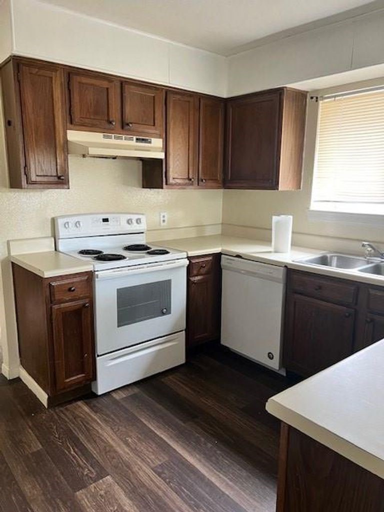 4409 Rattan Avenue Bay City, TX 77414 - Photo 7 of 13 a kitchen with a sink a stove and cabinets