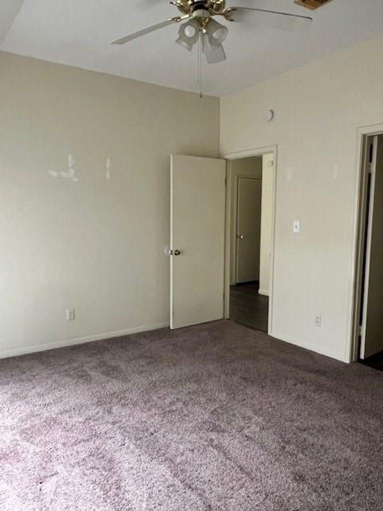 4409 Rattan Avenue Bay City, TX 77414 - Photo 10 of 13 an empty room with a ceiling fan and a window