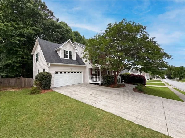 a front view of a house with a yard and garage