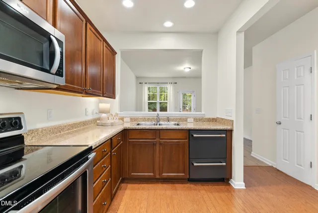 a kitchen with a sink and stove top oven