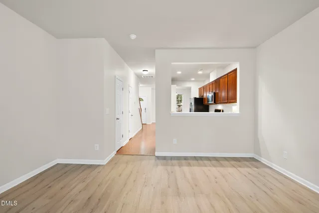a view of kitchen and hall with wooden floor