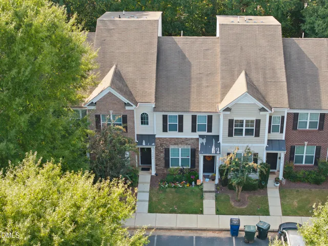 front view of a brick house with a yard