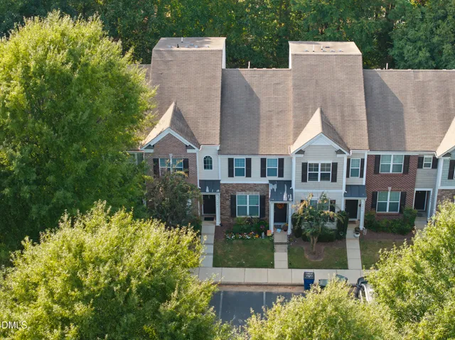 an aerial view of a house with swimming pool and glass windows