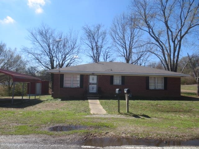 6386 Highway 209 Ripley, TN 38063 - Photo 2 of 23 Ranch-style house featuring a front yard, brick siding, and a carport
