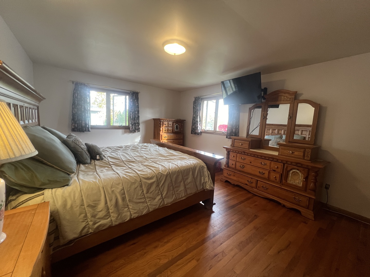 1380 South Regan Road New Lenox, IL 60451 - Photo 15 of 39 a spacious bedroom with a bed a mirror on dresser and a window