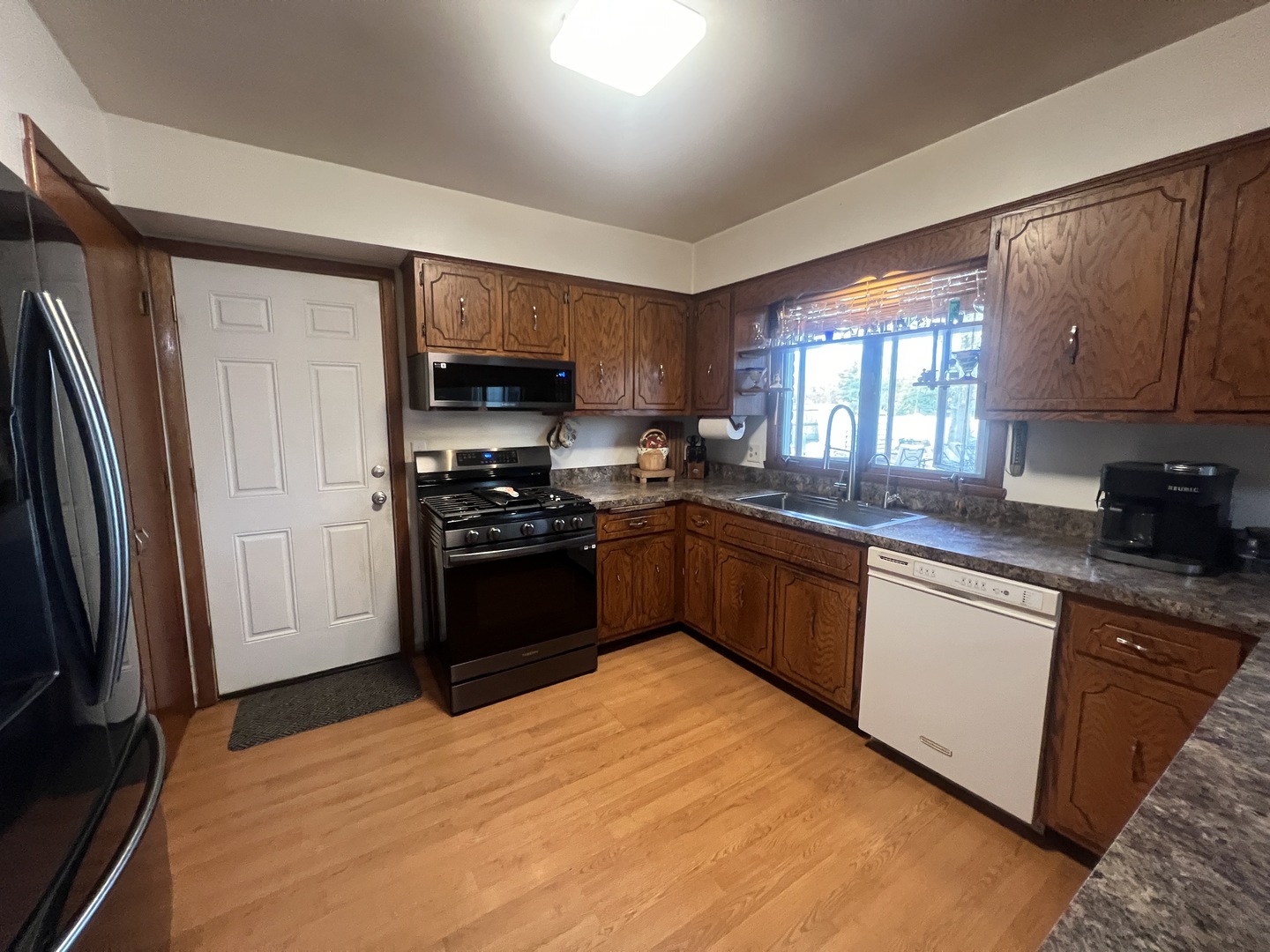 1380 South Regan Road New Lenox, IL 60451 - Photo 7 of 39 a kitchen with stainless steel appliances granite countertop a refrigerator sink and stove