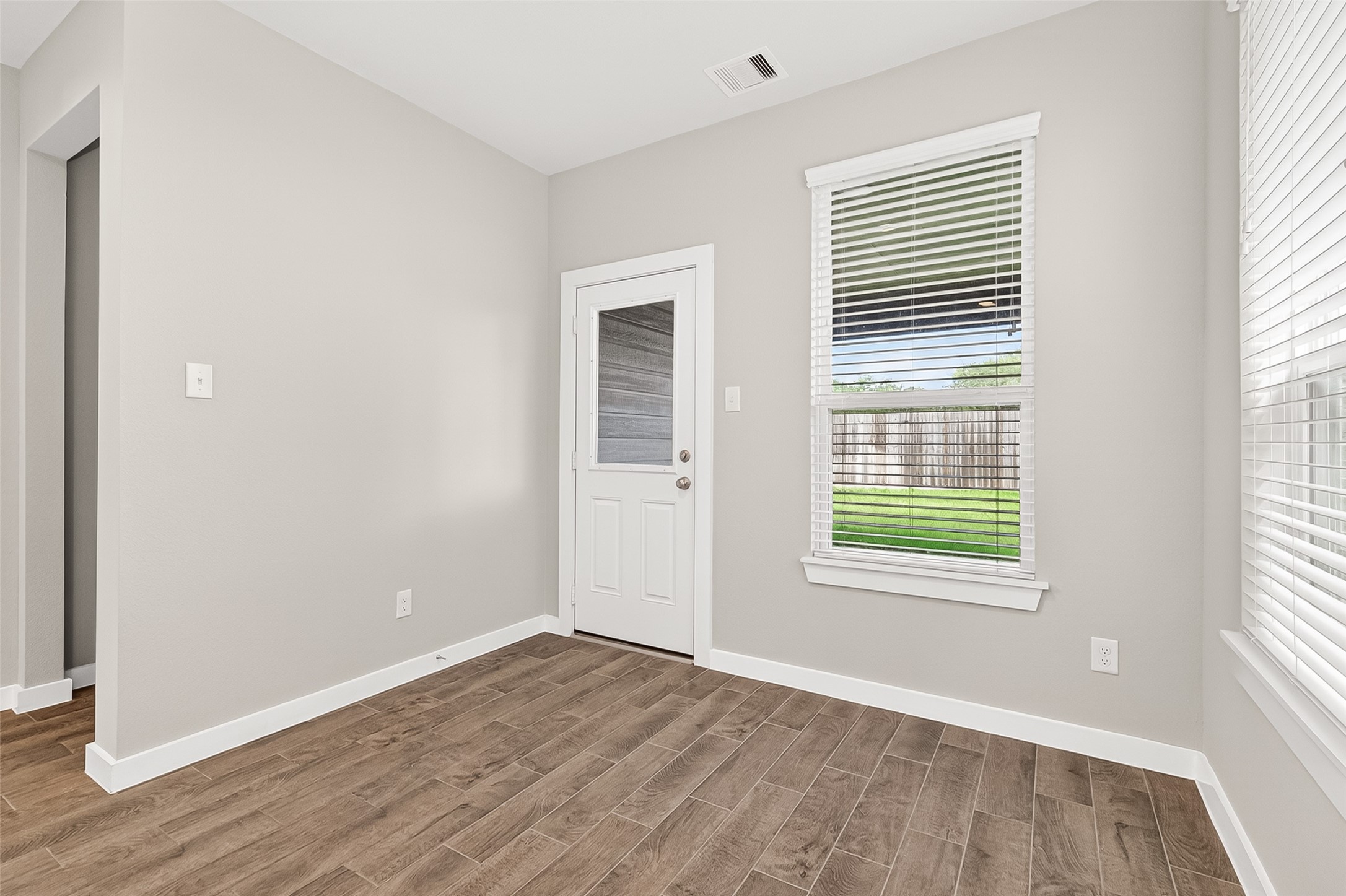 2142 Reed Cave Lane Spring, TX 77386 - Photo 22 of 50 an empty room with wooden floor and windows