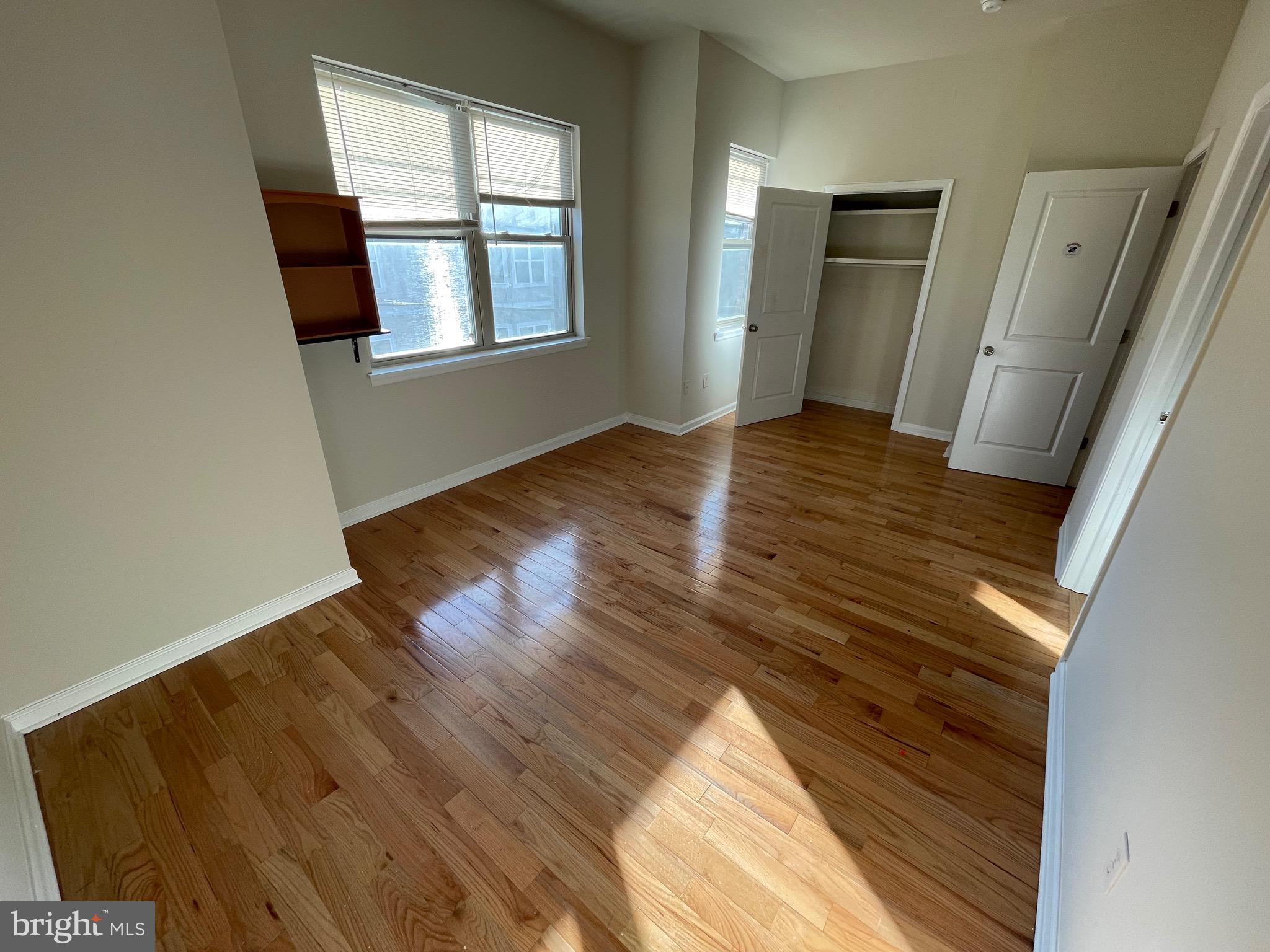 408 Wiota Street Philadelphia, PA 19104 - Photo 15 of 25 a view of an empty room with wooden floor and a window