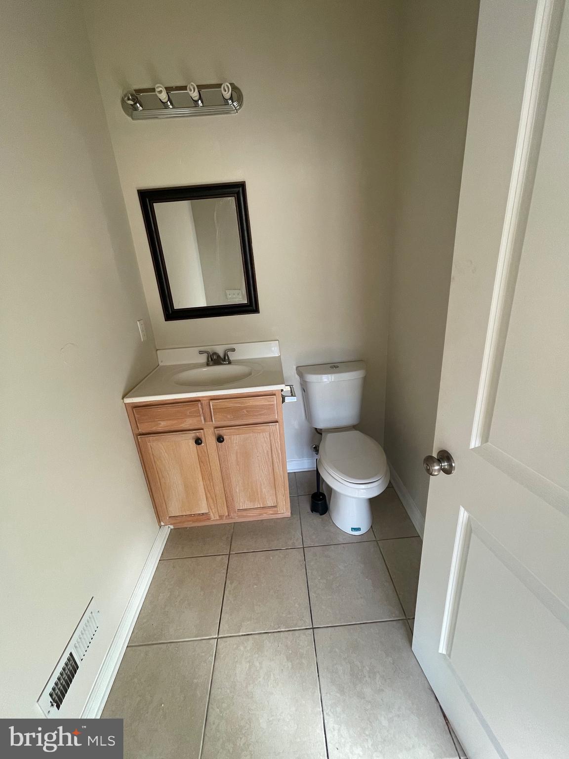 408 Wiota Street Philadelphia, PA 19104 - Photo 17 of 25 a bathroom with a toilet sink and mirror
