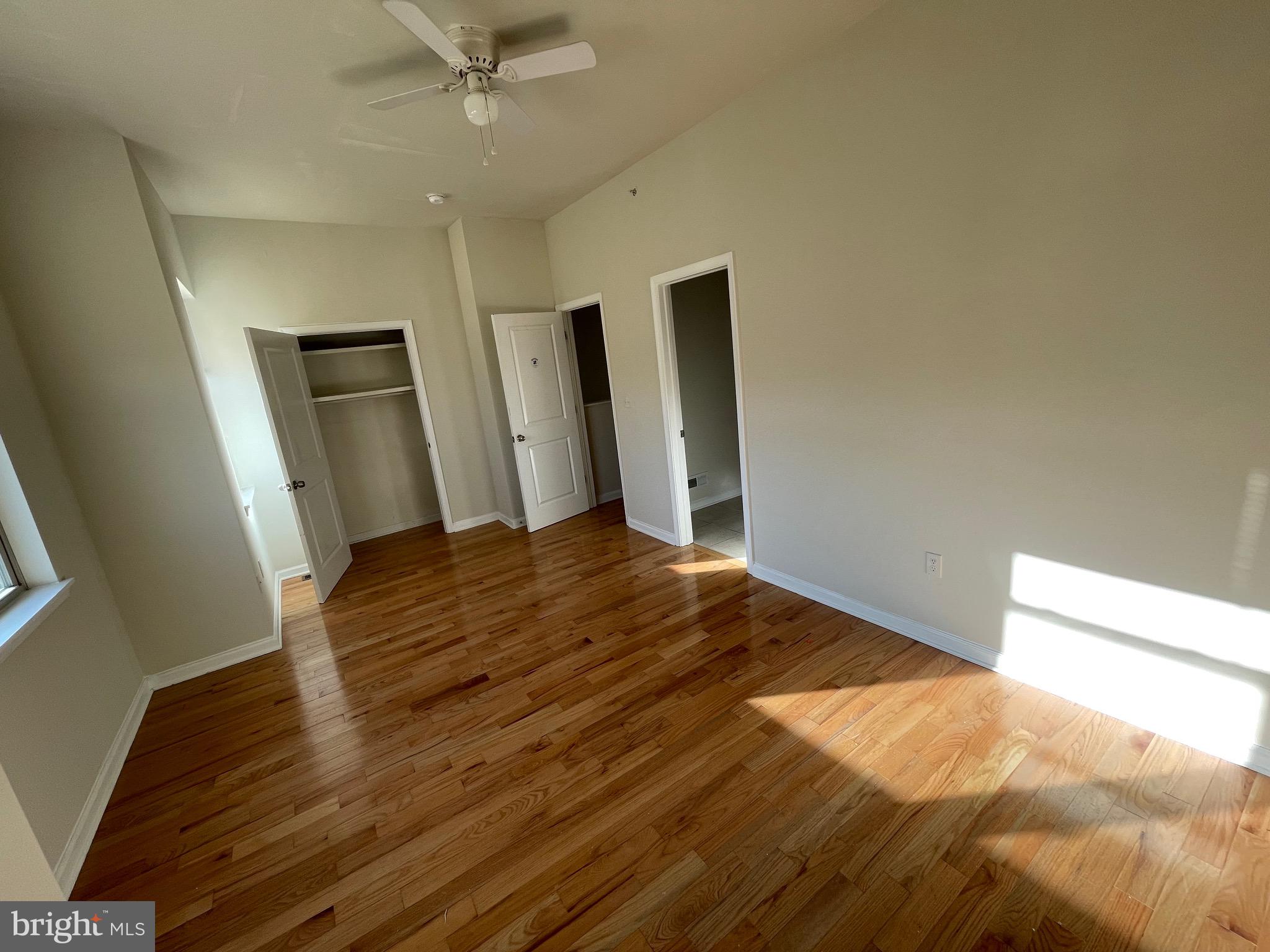 408 Wiota Street Philadelphia, PA 19104 - Photo 18 of 25 a view of a big room with wooden floor and ceiling fan
