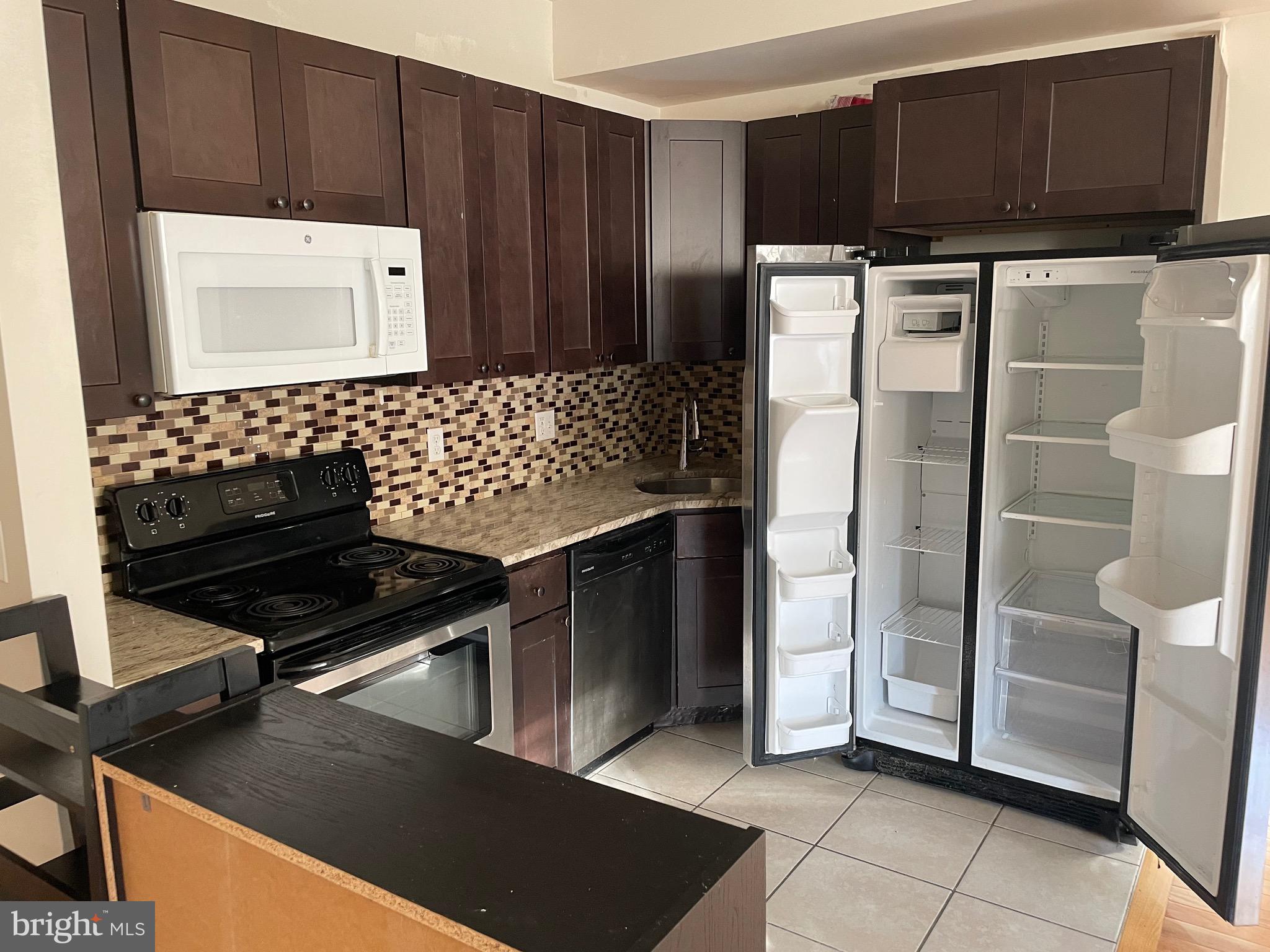 408 Wiota Street Philadelphia, PA 19104 - Photo 2 of 25 a kitchen with stainless steel appliances a refrigerator and a stove