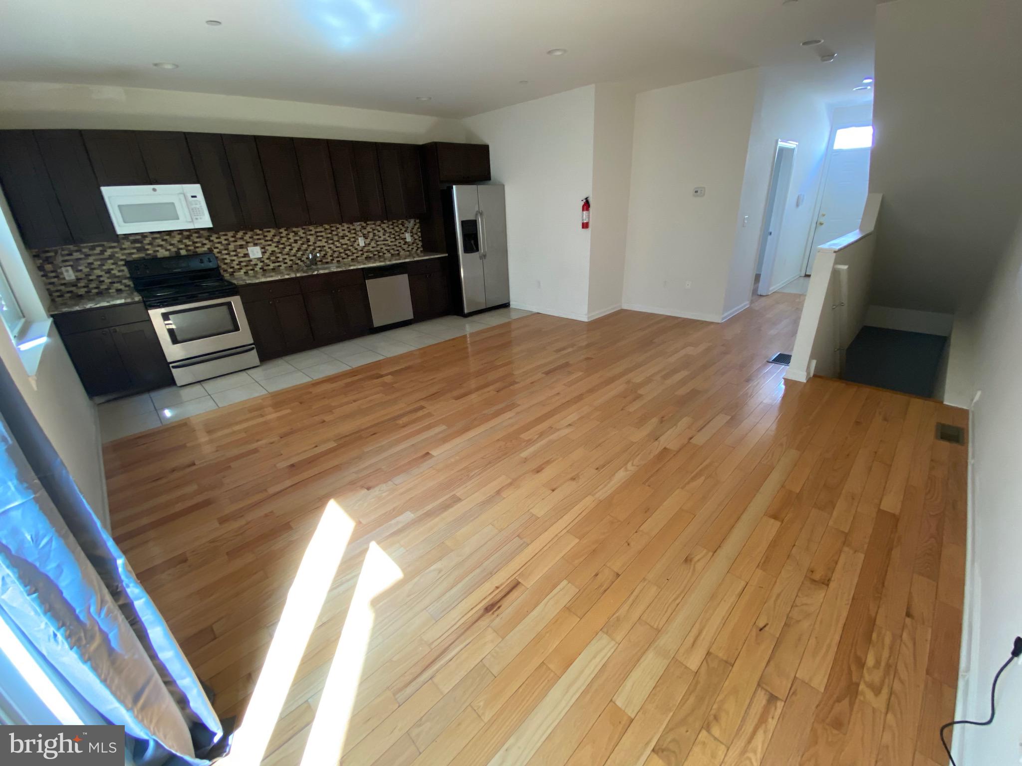 408 Wiota Street Philadelphia, PA 19104 - Photo 21 of 25 a bedroom with a bed and a view of kitchen