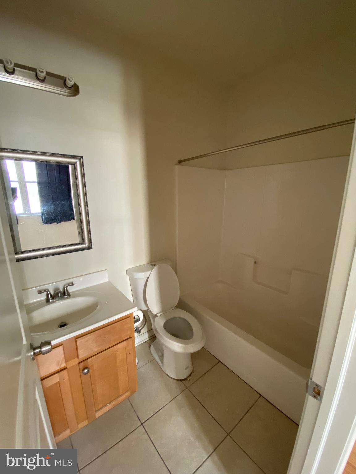 408 Wiota Street Philadelphia, PA 19104 - Photo 24 of 25 a bathroom with a granite countertop sink mirror and toilet