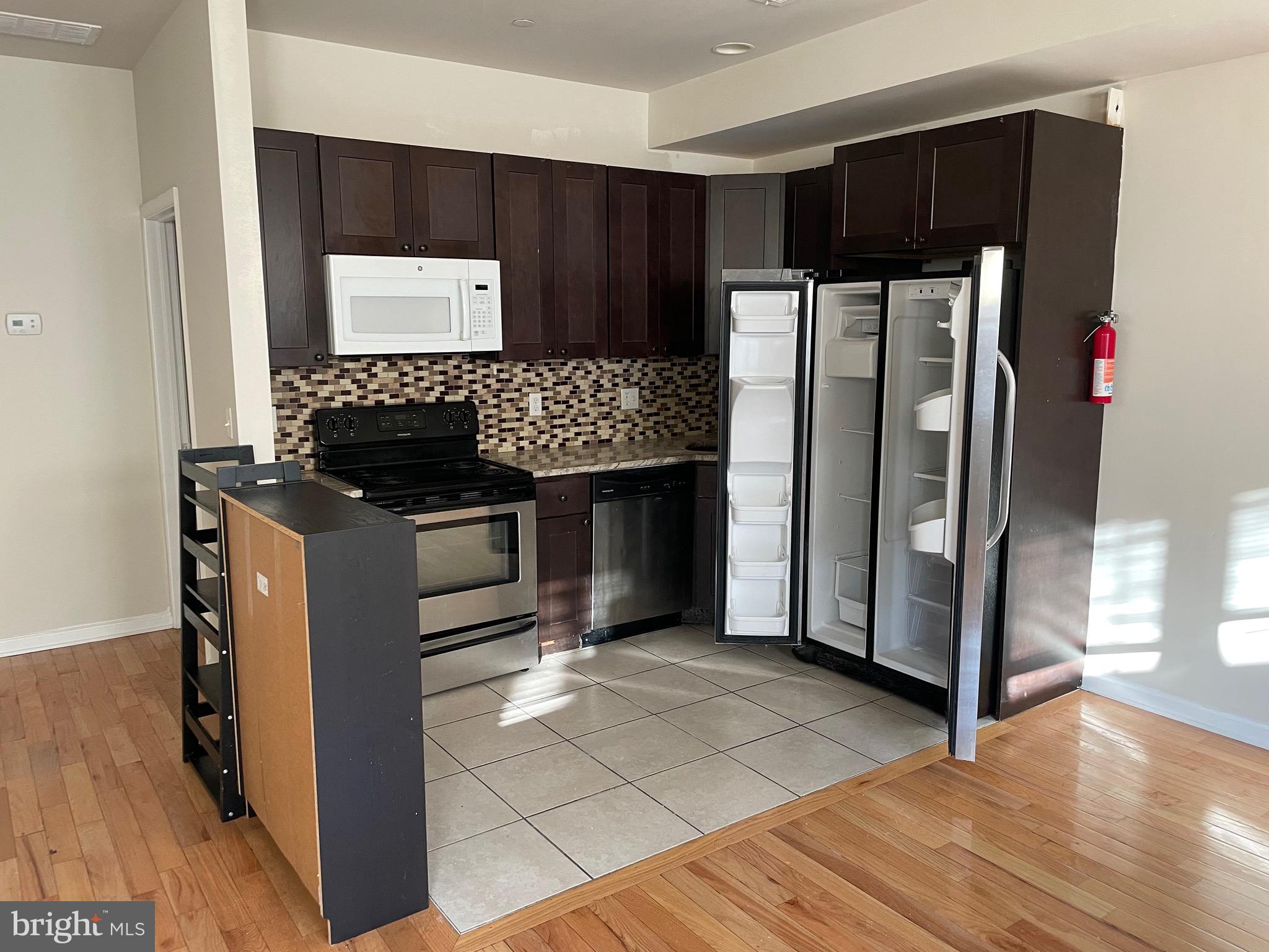 408 Wiota Street Philadelphia, PA 19104 - Photo 4 of 25 a kitchen with stainless steel appliances a refrigerator and a stove top oven
