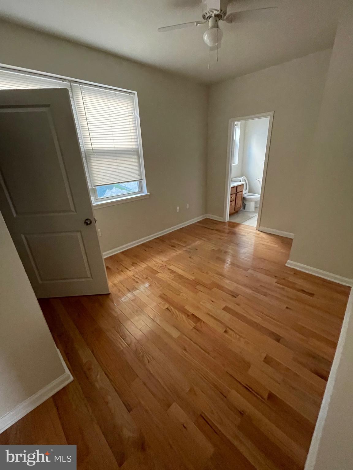 408 Wiota Street Philadelphia, PA 19104 - Photo 8 of 25 wooden floor in an empty room with a window