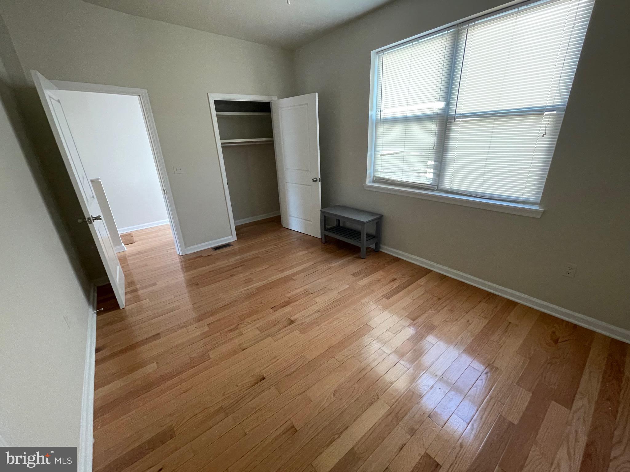 408 Wiota Street Philadelphia, PA 19104 - Photo 9 of 25 an empty room with wooden floor and windows