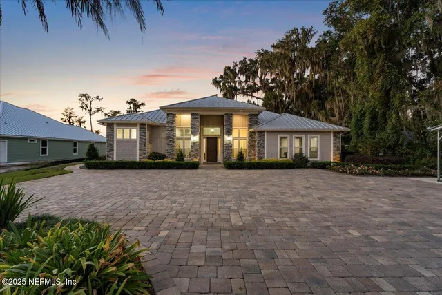 a front view of a house with a yard and a garage