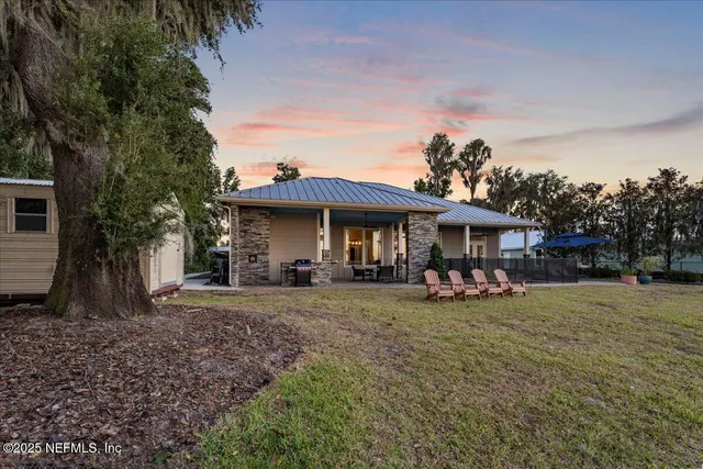 a view of a backyard with sitting area
